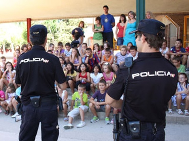Dous policías falan cun grupo de nenos