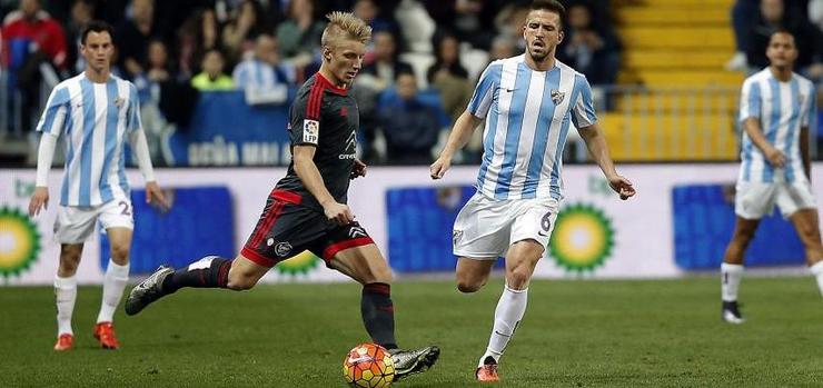Daniel Wass golpea o balón ante a chegada de Camacho. 