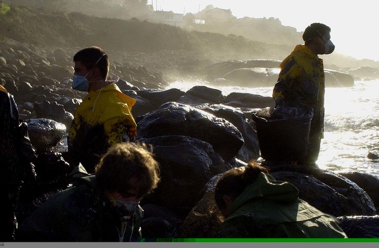 Voluntarios limpan rochas contaminadas polo chapapote do 'Prestige' 