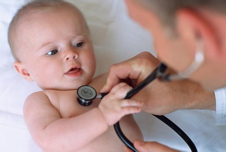 Pediatra na consulta cun bebé 