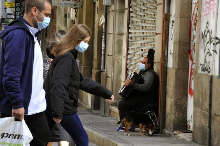 Veciños de Ourense camiñan por unha das rúas do barrio do Couto o mesmo día no que se prohibiron as reunións entre non conviventes ante o aumento de contaxios de Covid-19, a 3 de outubro de 2020 