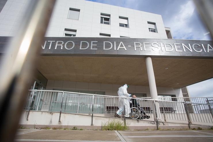 Un traballador sanitario totalmente protexido acoden a buscar a un ancián da residencia de anciáns de San Cibrao onde se orixinou un brote de Covid-19, en San Cibrao, Lugo, Galicia, (España), a 9 de novembro de 2020. No centro a situación ac. Carlos Castro - Europa Press / Europa Press