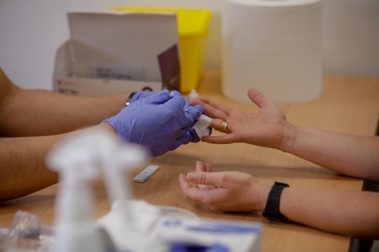 Persoal sanitario de Cruz Vermella saca sangue dun dedo a unha persoa para realizar o test rápido. Foto de arquivo.. Ricardo Rubio - Europa Press