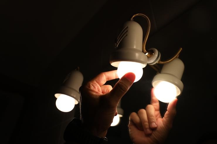 Unha persoa cambia a lámpada dunha lámpada, o día en que o prezo da luz bate unha marca histórica alcanzando os 124,45 euros por megawatt hora, a 30 de agosto de 2021, en Madrid, (España). Supón unha subida de dous euros respecto ao máximo anteri. Marta Fernández - Europa Press 