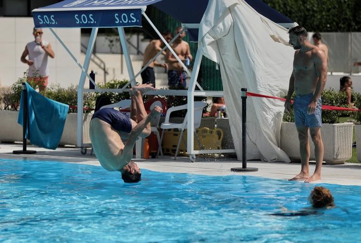 Un home tírase de cabeza á auga na piscina municipal de Casa de Campo / Eduardo Parra