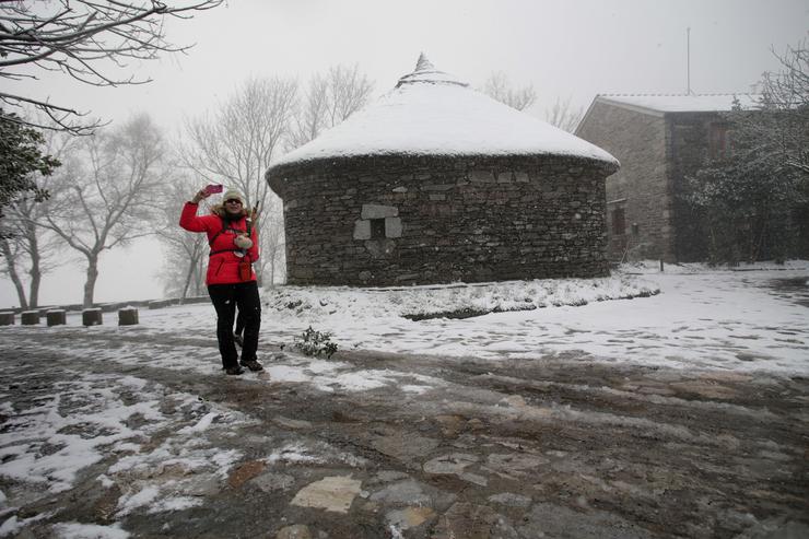 Unha turista faise unha foto mentres nieva na parroquia de Ou Cebreiro onde nevou, a 15 de xaneiro de 2023, en Pedrafita do Cebreiro, Lugo, Galicia.. Carlos Castro - Europa Press / Europa Press