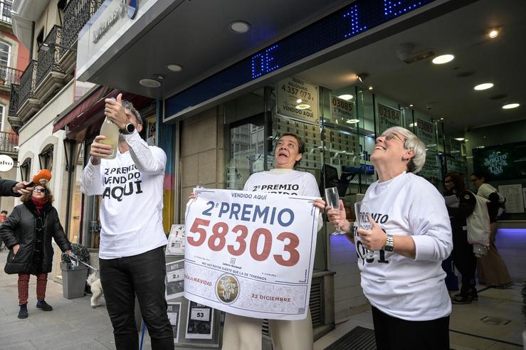 Empregados da administración O Filón de Ouro, celebran que venderon parte do número 88008 correspondente ao Segundo Premio do Sorteo Extraordinario da Lotaría de Nadal, a 22 de decembro de 2023, na Coruña 