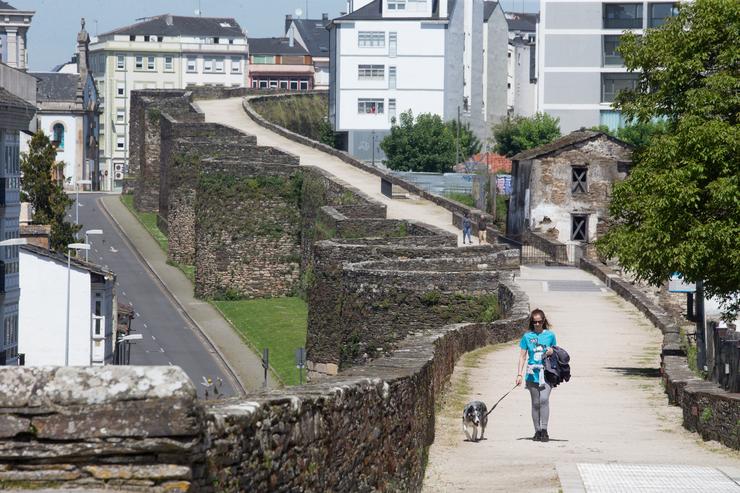 Unha muller pasea ao seu can durante o Día da Nai e o segundo día de desconfinamiento dos adultos, en Lugo/Galicia (España) a 3 de maio de 2020.. Carlos Castro - Europa Press / Europa Press