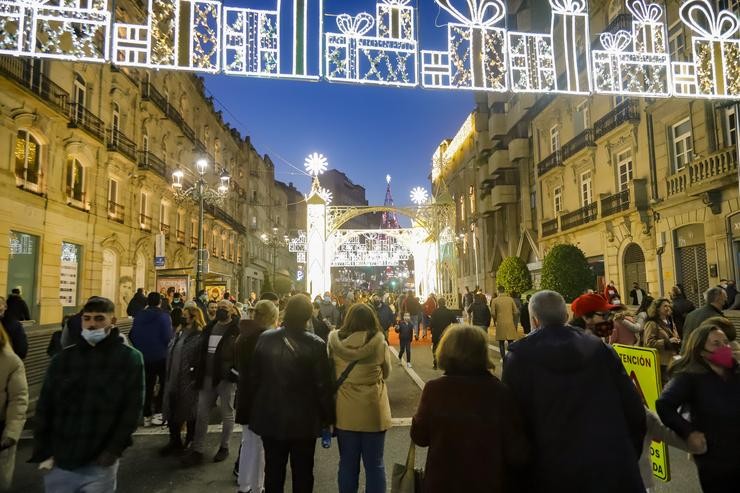 Un grupo de persoas observa o aceso do Nadal tras varios días de choiva, a 12 de decembro de 2021, en Vigo, Galicia (España). A Axencia Estatal de Meteoroloxía (AEMET) espera que o tempo se estabilice este domingo, cando irán remitindo as pre. Marta Vázquez Rodríguez - Europa Press