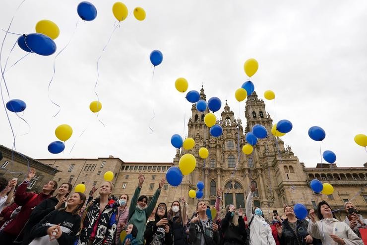 Varias persoas lanzan globos ao aire como xesto para o fin da guerra en Ucraína, na praza do Obradoiro, a 25 de marzo de 2022 