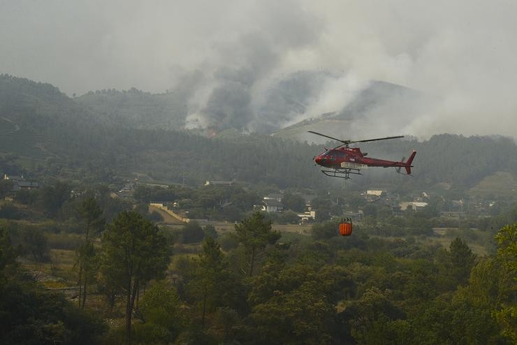 Un helicóptero traballa na extinción do incendio, a 18 de xullo de 2022, no Barco de Valdeorras, Ourense, Galicia (España). A superficie arrasada polos principais incendios rexistrados en Galicia xa supera as 9.000 hectáreas, segundo as estimacio. Rosa Veiga - Europa Press 