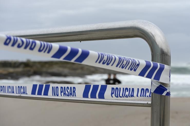 Aviso da policía local de non pasar nunha praia pechada na Coruña / M. Dylan - Europa Press 