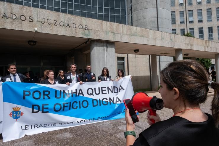 Avogados da quenda de oficio suxeitan unha pancarta durante unha manifestación, a 12 de xullo de 2023, en Santiago de Compostela, A Coruña, Galicia (España). A esta folga, convocada polo Sindicato de Avogados Venia, foron convocados os letrados que pr. César Arxina - Europa Press