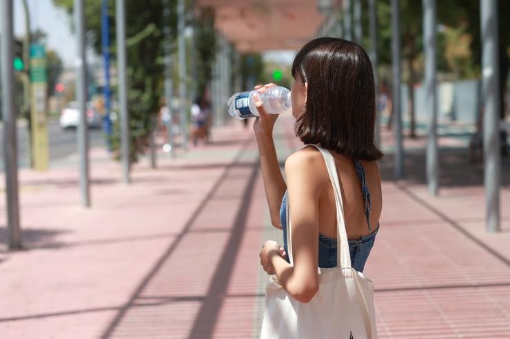 Unha moza bebe auga para refrescarse ante as altas temperaturas, a 24 de agosto en Sevilla / Rocío Ruz - Arquivo