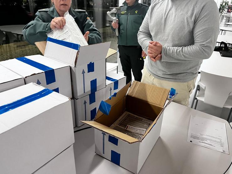 Axentes da Garda Civil custodian e comproban as caixas que conteñen as probas de oposición para ingresar ao Instituto Armado. GARDA CIVIL / Europa Press